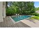 Inviting backyard pool surrounded by lush landscaping and a wooden deck with lounge chairs at 4015 Wieuca Ne Rd, Atlanta, GA 30342