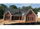 New construction brick home showing architectural details, windows, and a newly installed roof at 101 Deer Canyon Dr, Auburn, GA 30011