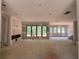 Unfinished living room featuring large windows, fireplace, and bare concrete floors at 101 Deer Canyon Dr, Auburn, GA 30011
