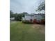 Back exterior featuring a wooden deck overlooking the well-manicured green lawn at 3414 Bayshore Dr, Atlanta, GA 30340