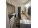 Bathroom with a single sink vanity, speckled granite countertop, and stacked washer and dryer at 3414 Bayshore Dr, Atlanta, GA 30340