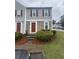 Inviting townhouse with stone accents and red shutters, surrounded by manicured landscaping at 3414 Bayshore Dr, Atlanta, GA 30340