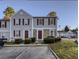 Charming townhouse featuring stone accents, red shutters, and well-maintained landscaping at 3414 Bayshore Dr, Atlanta, GA 30340