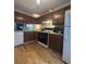 Well-lit kitchen featuring wooden cabinets, modern appliances, and wood-look floors at 3414 Bayshore Dr, Atlanta, GA 30340