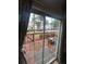 View through sliding glass doors to the home's small wooden patio at 3414 Bayshore Dr, Atlanta, GA 30340