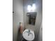 Small powder room with a pedestal sink and decorative mirror at 3414 Bayshore Dr, Atlanta, GA 30340