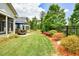 Spacious backyard featuring a patio with dining set, manicured lawn, and lush landscaping at 422 Laurel Spring Ct, Canton, GA 30114