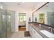 Bathroom with double sink vanity, large mirror, and glass enclosed shower at 422 Laurel Spring Ct, Canton, GA 30114