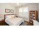 Cozy bedroom with queen bed, natural light, and wood floors at 422 Laurel Spring Ct, Canton, GA 30114