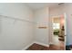 Walk-in closet with ample storage and wood floors, leading to laundry room at 422 Laurel Spring Ct, Canton, GA 30114