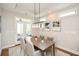 Bright dining room with French doors leading to a covered porch, and modern light fixture at 422 Laurel Spring Ct, Canton, GA 30114