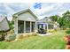 Rear exterior view of the home with a screened porch and patio dining area at 422 Laurel Spring Ct, Canton, GA 30114