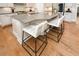 Modern kitchen island with stone countertops and two bar stools on hardwood flooring at 422 Laurel Spring Ct, Canton, GA 30114