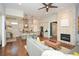 Open-concept living area with a stone fireplace, hardwood floors, and a modern kitchen at 422 Laurel Spring Ct, Canton, GA 30114