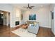 Inviting living room with a striking brick fireplace, hardwood floors, and stylish decor at 422 Laurel Spring Ct, Canton, GA 30114