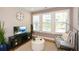 Small living room with hardwood flooring, many windows with shutters, and stylish decor at 422 Laurel Spring Ct, Canton, GA 30114