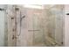 Walk-in shower featuring glass door, shower bench, and neutral tiling at 422 Laurel Spring Ct, Canton, GA 30114