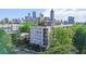 Aerial view of the apartment building in a green, residential neighborhood with a city skyline backdrop at 525 Parkway Ne Dr # 110, Atlanta, GA 30354