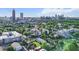 An aerial view of the apartment building surrounded by trees with the city skyline in the distance at 525 Parkway Ne Dr # 110, Atlanta, GA 30354