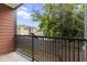 Balcony featuring wood railing and a serene view of green trees and a neighboring building at 525 Parkway Ne Dr # 110, Atlanta, GA 30354