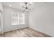 Bright bedroom with wood floors, a modern chandelier, and a large window at 525 Parkway Ne Dr # 110, Atlanta, GA 30354