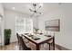 Bright dining room featuring modern chandelier, marble top table, and large window for natural light at 525 Parkway Ne Dr # 110, Atlanta, GA 30354