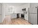 Bright, open kitchen with stainless steel appliances, modern white cabinets, and wood-look flooring, integrating seamlessly with living space at 525 Parkway Ne Dr # 110, Atlanta, GA 30354