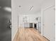 Bright living space flows into a modern kitchen with stainless steel appliances and sleek white cabinetry, enhanced by wood-look floors at 525 Parkway Ne Dr # 110, Atlanta, GA 30354