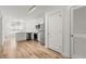 Modern living room adjacent to kitchen features stainless appliances, sleek white cabinetry, and wood-look flooring, maximizing space at 525 Parkway Ne Dr # 110, Atlanta, GA 30354