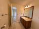 Bright bathroom featuring updated vanity with a granite countertop, modern lighting and a large mirror at 5307 Red Rock Trce, Powder Springs, GA 30127