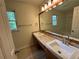 Well-lit bathroom featuring double sinks, wood-look flooring and updated fixtures at 5307 Red Rock Trce, Powder Springs, GA 30127
