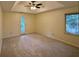 Bright bedroom with recessed ceiling, ceiling fan and door to the outside at 5307 Red Rock Trce, Powder Springs, GA 30127