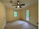 Neutral bedroom featuring a ceiling fan, carpet, and a door that leads outside at 5307 Red Rock Trce, Powder Springs, GA 30127