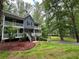 Charming two-story home with double porches surrounded by mature trees at 5307 Red Rock Trce, Powder Springs, GA 30127