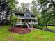 Charming two-story home featuring double balconies and a lush, green lawn with mature trees at 5307 Red Rock Trce, Powder Springs, GA 30127