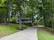 Two story home with inviting front porch, set amongst mature trees and professional landscaping at 5307 Red Rock Trce, Powder Springs, GA 30127