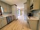 Kitchen with stainless steel dishwasher and open view into dining area at 5307 Red Rock Trce, Powder Springs, GA 30127