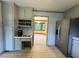 Kitchen featuring stainless steel refrigerator, grey cabinetry, and a view into another room at 5307 Red Rock Trce, Powder Springs, GA 30127