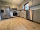 Well-lit kitchen featuring stainless steel appliances, light gray cabinets and wood grain flooring at 5307 Red Rock Trce, Powder Springs, GA 30127