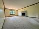 Spacious living room with neutral carpet, a brick fireplace and large window at 5307 Red Rock Trce, Powder Springs, GA 30127