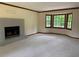 Sun-filled living room featuring a brick fireplace and large windows offering pleasant views of the outdoors at 5307 Red Rock Trce, Powder Springs, GA 30127