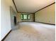 Living room with neutral carpet, brick fireplace, trim and bay window overlooking a wooded area at 5307 Red Rock Trce, Powder Springs, GA 30127