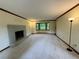 Large living room with neutral carpet, brick fireplace, and natural lighting at 5307 Red Rock Trce, Powder Springs, GA 30127