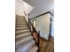 Carpeted stairway with wood banister and trim, leading to the upper level at 5307 Red Rock Trce, Powder Springs, GA 30127