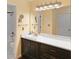 Bathroom vanity featuring dark wood cabinets, white countertop, and a large mirror at 1312 Pine Heights Ne Dr, Atlanta, GA 30324