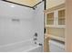 Bathroom featuring a tub with white subway tile surround and built in storage at 1312 Pine Heights Ne Dr, Atlanta, GA 30324