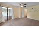 Spacious bedroom with carpet, ceiling fan, backyard access and open doorway to another room at 1312 Pine Heights Ne Dr, Atlanta, GA 30324