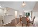 Dining area with hardwood floors open to the living room and kitchen featuring a fireplace at 1312 Pine Heights Ne Dr, Atlanta, GA 30324