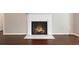 Close-up of the living room fireplace with a white mantel and marble hearth on hardwood floors at 1312 Pine Heights Ne Dr, Atlanta, GA 30324