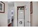 Hallway laundry closet with stacked washer and dryer tucked behind a white door at 1312 Pine Heights Ne Dr, Atlanta, GA 30324